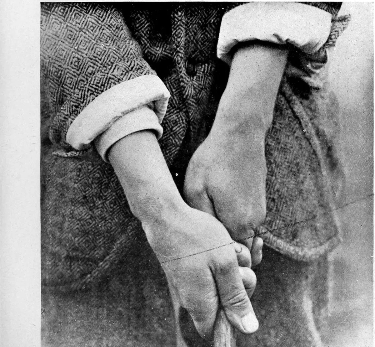 The overlapping grip seen from the player's view: trail pinky resting on the lead index finger